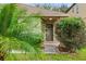 Home's front door framed by lush greenery, enhancing its curb appeal and welcoming atmosphere at 16817 Gold Star Ct, Clermont, FL 34714