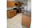 Functional kitchen features oak cabinets, stainless steel appliances and laminate countertops at 16817 Gold Star Ct, Clermont, FL 34714