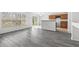 Open living area with gray wood floors and an eat-in kitchen area at 16817 Gold Star Ct, Clermont, FL 34714