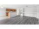 Open living area with gray wood floors, eat-in kitchen, and lots of natural light at 16817 Gold Star Ct, Clermont, FL 34714
