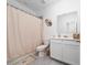Bathroom with shower and decorative mirror and basket weave wall hangings at 171 Bogey Dr, Davenport, FL 33896