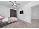 Bright bedroom with neutral carpet, ceiling fan, and gray blackout curtains at 171 Bogey Dr, Davenport, FL 33896