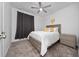 This bedroom features a cozy interior, soft carpet, a stylish ceiling fan, and a charming nightstand at 171 Bogey Dr, Davenport, FL 33896