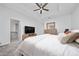 Spacious bedroom with neutral carpet, ceiling fan, TV, and attached bathroom at 171 Bogey Dr, Davenport, FL 33896