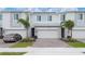 Beautiful townhome with modern architectural details, a paved driveway, and professionally landscaped yard at 171 Bogey Dr, Davenport, FL 33896