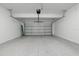 Spacious two-car garage with a clean, epoxy-coated floor and a new garage door ready for use at 171 Bogey Dr, Davenport, FL 33896