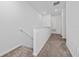 Hallway featuring neutral carpet, white walls and trim, and access to other rooms at 171 Bogey Dr, Davenport, FL 33896