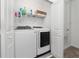 Well-equipped laundry room showcasing a modern washer and dryer set with convenient shelving for storage at 171 Bogey Dr, Davenport, FL 33896