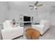 Well-lit living room with comfortable seating and entertainment center at 171 Bogey Dr, Davenport, FL 33896