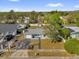 Aerial view showcasing the home's well-maintained lawn, driveway, and proximity to lush greenery at 1868 Wayside Dr, Orlando, FL 32818