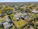 An aerial view showcases the property within its neighborhood, highlighting the yard and surrounding trees at 1868 Wayside Dr, Orlando, FL 32818