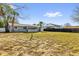 Expansive backyard featuring a clothesline, grass, partial fencing, and the back of the house at 1868 Wayside Dr, Orlando, FL 32818