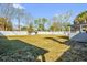 Large backyard with mature trees and a white fence, offering privacy and space for outdoor activities at 1868 Wayside Dr, Orlando, FL 32818