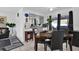 Well-lit dining area connected to the living space, featuring a modern table set and access to the adjacent kitchen at 1868 Wayside Dr, Orlando, FL 32818