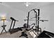 Bright room filled with workout equipment, including weight machine and treadmill, for fitness enthusiasts at 1868 Wayside Dr, Orlando, FL 32818