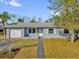 Charming single-story home featuring a well-maintained lawn and a classic front facade, complete with attached garage at 1868 Wayside Dr, Orlando, FL 32818