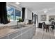 Bright kitchen features a stainless steel sink, ample counter space, and a view to the outdoor living spaces at 1868 Wayside Dr, Orlando, FL 32818