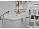 A simple laundry area with a white washing machine, water heater and adjacent to the kitchen at 1868 Wayside Dr, Orlando, FL 32818