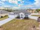 An aerial view of a well-maintained house with a spacious front yard and white fencing at 1949 Manatee Dr, Kissimmee, FL 34759