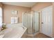 Bright bathroom featuring a soaking tub and shower with tile surround at 1949 Manatee Dr, Kissimmee, FL 34759