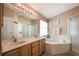 Relaxing bathroom features dual sinks, soaking tub, and separate shower at 1949 Manatee Dr, Kissimmee, FL 34759