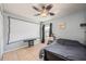 This bedroom has a ceiling fan and a window with room darkening curtains at 1949 Manatee Dr, Kissimmee, FL 34759