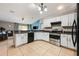 Open-concept kitchen boasts modern appliances and breakfast bar overlooking living area at 1949 Manatee Dr, Kissimmee, FL 34759