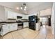 Bright kitchen features white cabinetry, stainless steel appliances, and ample counter space at 1949 Manatee Dr, Kissimmee, FL 34759