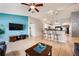 Bright living room with barstool seating, open floor plan, blue accent wall, and tile flooring at 1949 Manatee Dr, Kissimmee, FL 34759