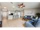 Bright living room with open floor plan, tile flooring, barstool seating, and modern finishes at 1949 Manatee Dr, Kissimmee, FL 34759