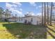 Expansive backyard with lush green grass, a golf cart, and a view of neighboring homes at 1959 9Th Ave, Deland, FL 32724