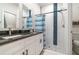 Modern bathroom featuring double sinks, sleek white cabinetry, and a shower with blue accents at 1959 9Th Ave, Deland, FL 32724