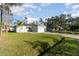Single-story home on a lush lawn featuring a paved driveway and an attached two-car garage at 1959 9Th Ave, Deland, FL 32724