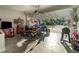 Spacious garage featuring a motorcycle, tool chests, and comfortable seating area at 1959 9Th Ave, Deland, FL 32724