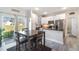 Modern kitchen featuring stainless steel appliances, white cabinets, and a sliding door leading to a patio at 1959 9Th Ave, Deland, FL 32724