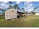A well-maintained storage shed in the backyard, ideal for storing tools and equipment at 1959 9Th Ave, Deland, FL 32724