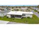Aerial view of the home features landscaping, carport, and a screen room at 200 Patricia Pl, Davenport, FL 33897