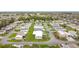 An aerial view showcases this manufactured home community with well-maintained streets and lush landscaping at 200 Patricia Pl, Davenport, FL 33897