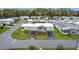 A top-down shot shows a home with a double carport, flower garden and community street layout at 200 Patricia Pl, Davenport, FL 33897