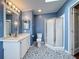 Newly renovated bathroom with glass enclosed shower, updated vanity, and stylish patterned flooring at 200 Patricia Pl, Davenport, FL 33897