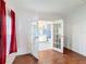En Suite bathroom access with french doors, wood flooring, and a view of the vanity at 200 Patricia Pl, Davenport, FL 33897