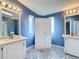 Spacious bathroom featuring dual vanities and sinks plus a large storage cabinet at 200 Patricia Pl, Davenport, FL 33897
