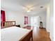Bedroom with wood-look floors, neutral paint, red curtains and ceiling fan at 200 Patricia Pl, Davenport, FL 33897
