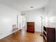 Bedroom featuring wood floors, dresser, bookcase, and a lamp at 200 Patricia Pl, Davenport, FL 33897