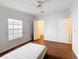 Bright bedroom features a ceiling fan, wood-look floors, and a window providing natural light at 200 Patricia Pl, Davenport, FL 33897