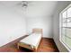 Bedroom with wood-look floors, neutral paint and a window providing natural light at 200 Patricia Pl, Davenport, FL 33897