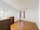 Bedroom with hardwood floors, a window with blinds, and a small bookcase at 200 Patricia Pl, Davenport, FL 33897