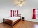 Bedroom with wood-look floors, neutral paint and red curtains at 200 Patricia Pl, Davenport, FL 33897