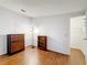 Bedroom with wood flooring, dresser, bookcase, and a ceiling light at 200 Patricia Pl, Davenport, FL 33897