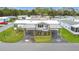 Charming home boasts a double carport, manicured lawn and a flower garden in a vibrant community at 200 Patricia Pl, Davenport, FL 33897